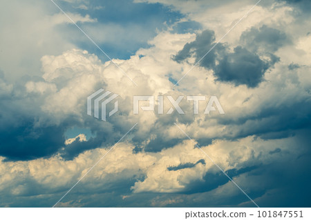 Light and dark of cumulonimbus clouds covering the sky where the weather suddenly changes a-3 Warm colors and cold colors emphasized 101847551
