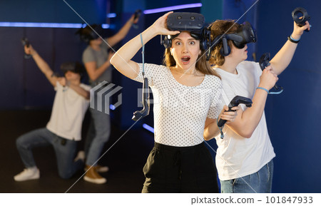 excited girl took off his virtual reality helmet to take little rest while VR play with brother excited girl took off his virtual reality helmet to take little rest while VR play with brother 101847933