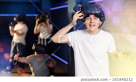 guy is exhilarated by turn of events in VR game and moved virtual reality glasses to forehead 101848212