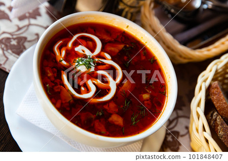 Traditional Russian meat soup solyanka with assorted meat and sausages and vegetables Traditional Russian meat soup solyanka with assorted meat and sausages and vegetables 101848407