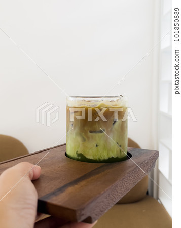 A glass of iced greentea and layer of coffee A glass of iced greentea and layer of coffee 101850889