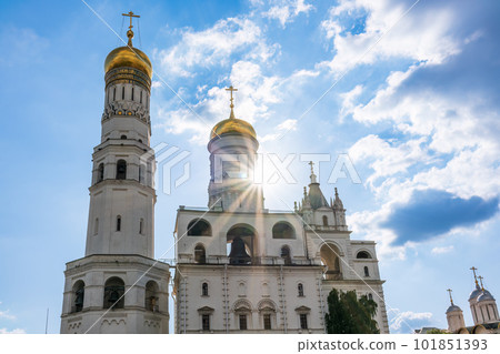 Ivan the Great Bell Tower, with Assumption Belfry on the right in Moscow Kremlin. Blue sky background with sunbeams 101851393
