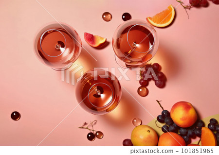 Fruit liquor in a wine glass, pink background 101851965