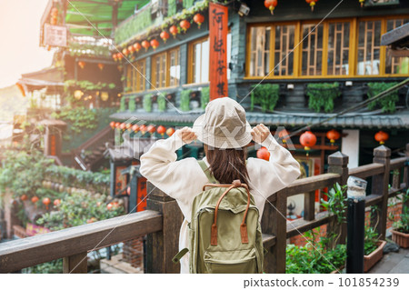woman traveler visiting in Taiwan, Tourist with hat and backpack sightseeing in Jiufen Old Street village with Tea House background. landmark and popular attractions near Taipei city. Travel concept woman traveler visiting in Taiwan, Tourist with hat and backpack sightseeing in Jiufen Old Street village with Tea House background. landmark and popular attractions near Taipei city. Travel concept 101854239