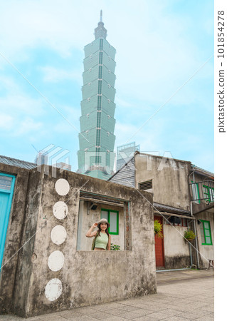 woman traveler visiting in Taiwan, happy Tourist sightseeing in Si Si Nan Cun or Old Military Village against Taipei city, landmark and popular attractions. Asia Travel,  vacation and Trip concept 101854278