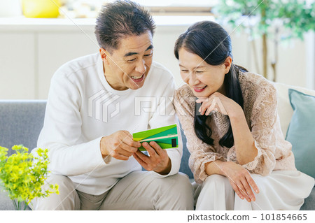 Senior couple laughing at the passbook 101854665