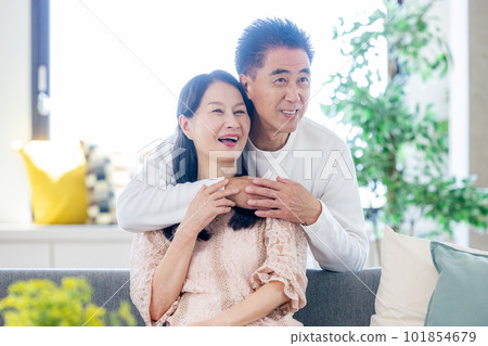 Senior couple relaxing in the living room Senior couple relaxing in the living room 101854679