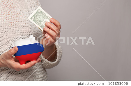 Flag of Russia on money bank in Russian woman hands.  101855096