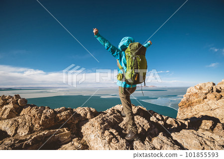 Woman hiker enjoy the ivew on mountain top cliff ege at lakeside Woman hiker enjoy the ivew on mountain top cliff ege at lakeside 101855593