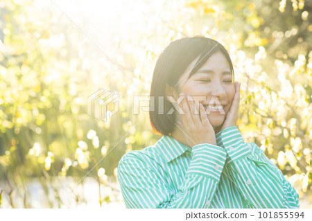 A woman basking in the morning sun A woman basking in the morning sun 101855594