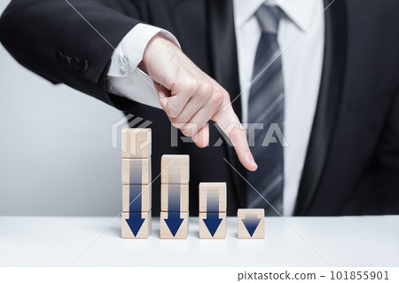 Wooden blocks with dark blue arrows icons, businessman in suit pointing down against background Wooden blocks with dark blue arrows icons, businessman in suit pointing down against background 101855901