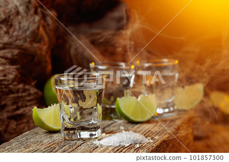 Tequila with salt and lime slices. 101857300