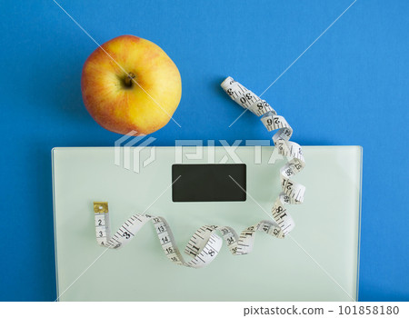 Electronic scales, centimeter tape and an apple 101858180