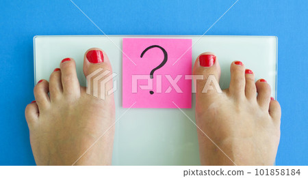 Electronic scales, a sticker with a question mark and female legs Electronic scales, a sticker with a question mark and female legs 101858184