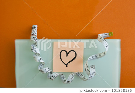 Electronic scales, sticker with a heart and centimeter tape 101858186