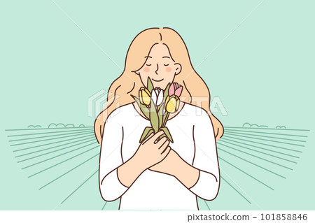 Smiling woman with bouquet of flowers plucked at countryside plantation for growing tulips Smiling woman with bouquet of flowers plucked at countryside plantation for growing tulips 101858846