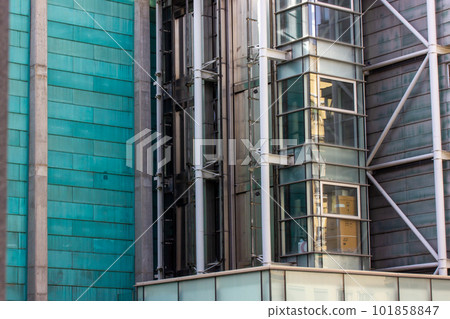 External glass elevator on office building, business shopping center. Transparent lift outside of a house. Lifting system. Modern urban city architectural details. Skyscraper elevators. Madrid, Spain. External glass elevator on office building, business shopping center. Transparent lift outside of a house. Lifting system. Modern urban city architectural details. Skyscraper elevators. Madrid, Spain. 101858847