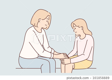 Mom holds hand of sad teenager daughter helps to get rid stress and consoles after quarrel 101858889