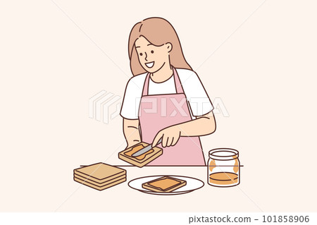 Woman spreads peanut butter on bread preparing sweet breakfast sandwich and smiles 101858906