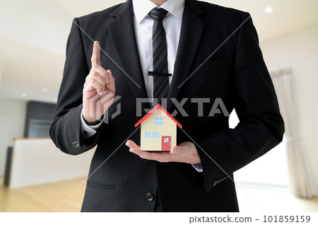 A housing salesman who raises his index finger 101859159
