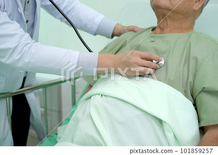 Elder Asian man sitting on the bed and talking to doctor about his physical injuries at his knees, elderly Asian man having a consulting with professional physical therapist or orthopedic doctor. Elder Asian man sitting on the bed and talking to doctor about his physical injuries at his knees, elderly Asian man having a consulting with professional physical therapist or orthopedic doctor. 101859257