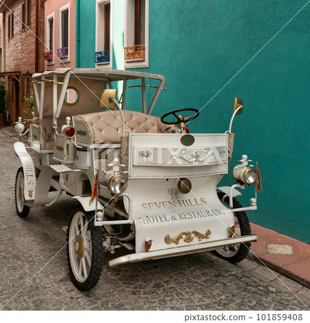 White antique car in a cobblestone alley over green wall, near Sultanahmet square, Fatih district, Istanbul, Turkey White antique car in a cobblestone alley over green wall, near Sultanahmet square, Fatih district, Istanbul, Turkey 101859408