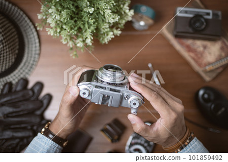 vintage camera in photographer's hand vintage camera in photographer's hand 101859492