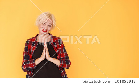 Funny pray. Begging woman. Asking favor. Pleading middle-aged lady holding hands in request gesture with hopeful face on yellow. Funny pray. Begging woman. Asking favor. Pleading middle-aged lady holding hands in request gesture with hopeful face on yellow. 101859915