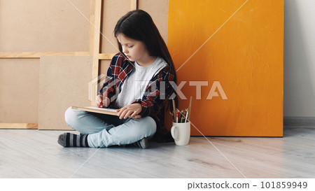 Painting time. Kids creativity. Inspired hobby. Little girl sitting floor drawing on paper in light room interior. 101859949