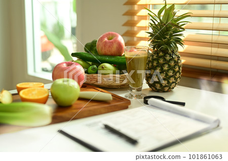 Fruit and vegetable on chopping board with Nutrition Facts on table. 101861063