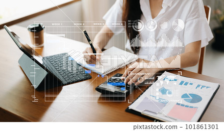 Businessman hand Project manager working and update tasks and Gantt chart scheduling virtual diagram.with smart phone, tablet and laptop in office.. Businessman hand Project manager working and update tasks and Gantt chart scheduling virtual diagram.with smart phone, tablet and laptop in office.. 101861301