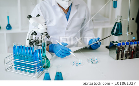 Scientist mixing chemical liquids in the chemistry lab. Researcher working in the laboratory Scientist mixing chemical liquids in the chemistry lab. Researcher working in the laboratory 101861327