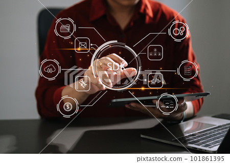 SDK  Software development kit programming language technology concept, Person typing laptop computer and tablet with SDK icon on virtual screen. 101861395