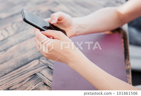 female hand holding mobile phone female hand holding mobile phone 101861506