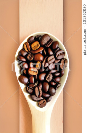 coffee beans in a wooden spoon 101862080