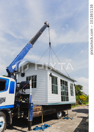 Crane lifting a knock down private house. 101863136