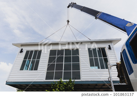 Crane lifting a knock down private house. 101863137