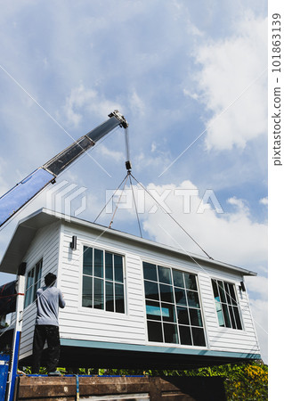 Crane lifting a knock down private house. Crane lifting a knock down private house. 101863139