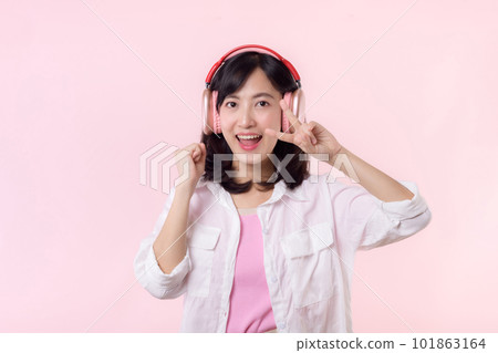 Smile pretty asian model person listen music song and enjoy dance with wireless headphone online audio radio sound. Positive fun exited joyful youth female woman on pink isolated background studio Smile pretty asian model person listen music song and enjoy dance with wireless headphone online audio radio sound. Positive fun exited joyful youth female woman on pink isolated background studio 101863164