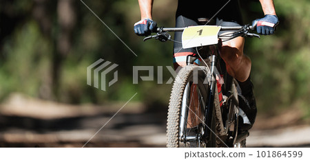 Mountain bikers riding on bike singletrack trail, mountain bike race 101864599