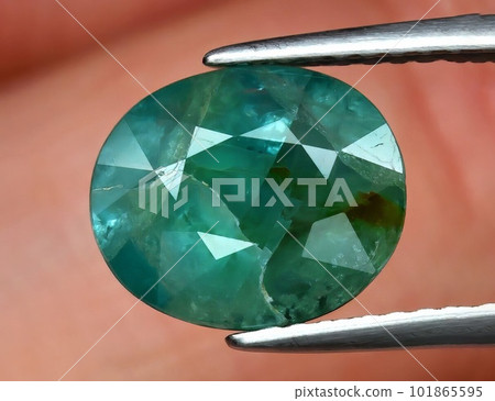 Natural gemstone green grandidierite on black background 101865595