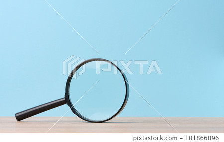 Black magnifier on a blue background. The concept of uncertainty and the search for solutions, doubts Black magnifier on a blue background. The concept of uncertainty and the search for solutions, doubts 101866096