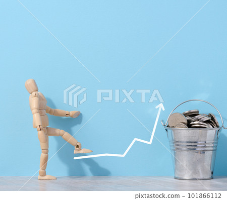 A wooden mannequin and coins in a miniature bucket on a blue background, a concept of high income A wooden mannequin and coins in a miniature bucket on a blue background, a concept of high income 101866112