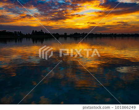 Water surface and clouds reflecting the sunset over a lake in Thailand 101866249