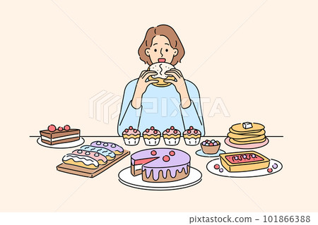 Woman sit at table eating numerous desserts  101866388