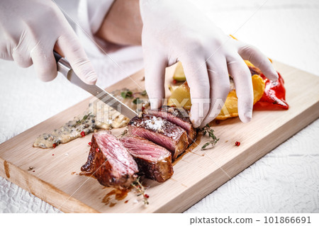 Chef cutting beef steak Chef cutting beef steak 101866691