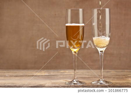 Champagne pouring in glass Champagne pouring in glass 101866775