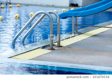 Ladder stainless handrails for descent into swimming pool. Swimming pool with handrail . Ladder stainless handrails for descent into swimming pool. Swimming pool with handrail . 101870516
