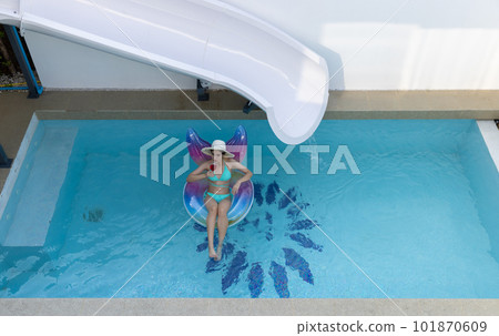 Woman in bikini with rubber inflatable float. Woman in swimsuit on the swim tube in swimming pool. Woman in bikini with rubber inflatable float. Woman in swimsuit on the swim tube in swimming pool. 101870609