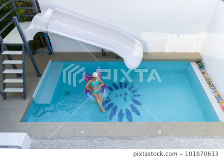 Woman in bikini with rubber inflatable float. Woman in swimsuit on the swim tube in swimming pool. Woman in bikini with rubber inflatable float. Woman in swimsuit on the swim tube in swimming pool. 101870613
